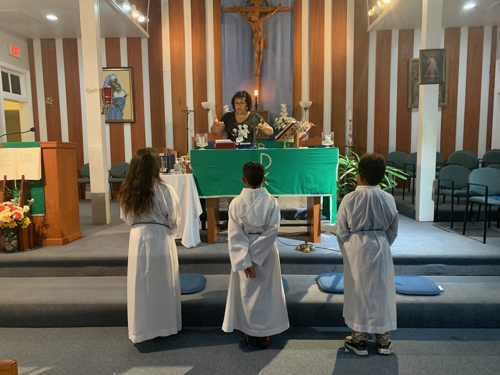 Catechist Chantel Normand explains to youth volunteers their duties as altar servers for the Mass