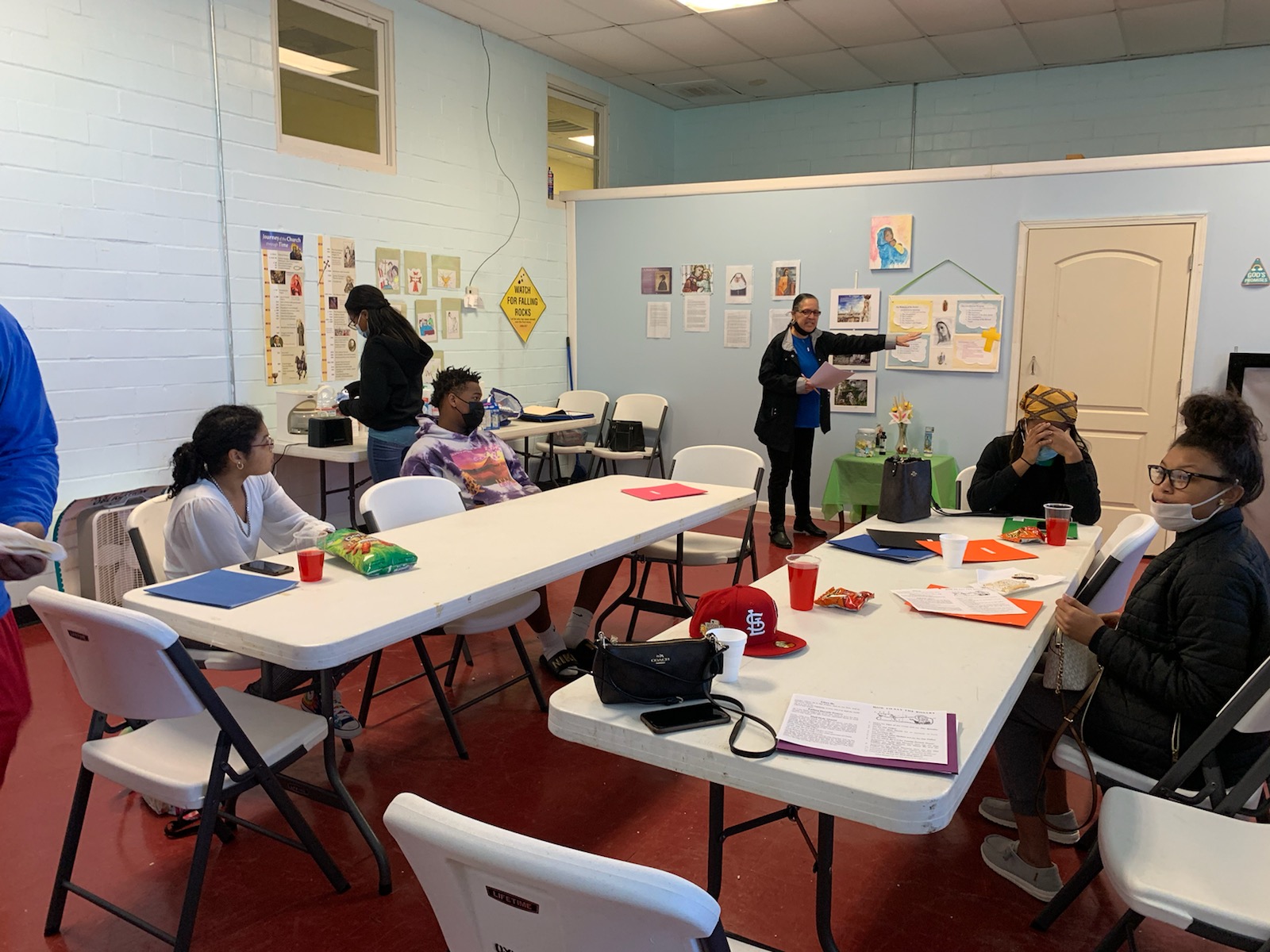 Catechist Mrs. Karen Cook teaches class the Mysteries of the Rosary and about the Saints