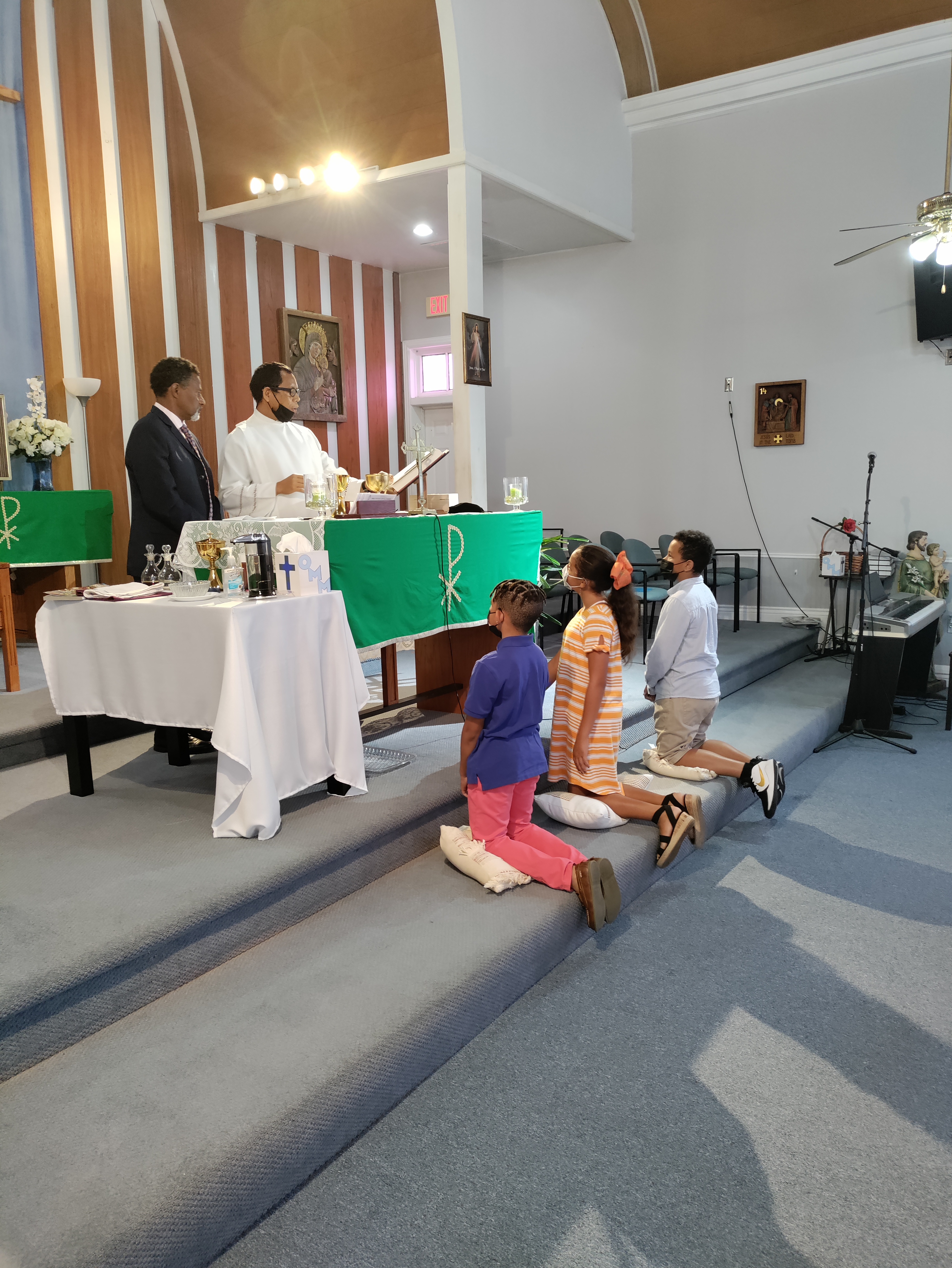 Fr. Rofinus Jas and Volunteer Aaron Barnes practice with Altar Servers