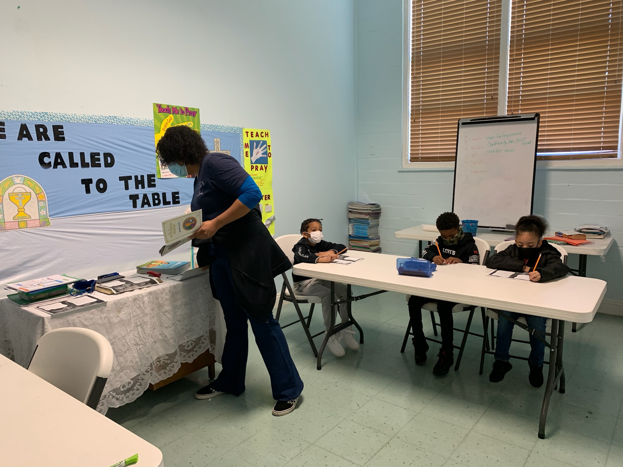 Sacraments of Reconciliation and First Holy Communion Catechist Ms. Chantel Normand teaches her class about the Mass as they prepare for First Holy Communion