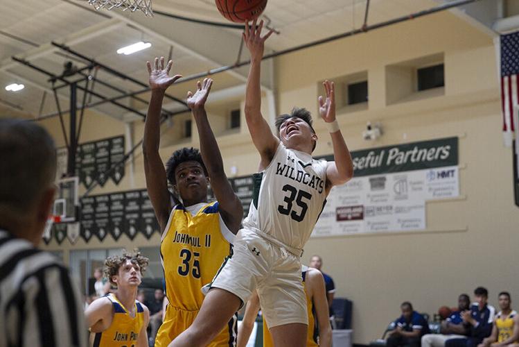 St. John Paul II graduate, Jayvenn Adams playing basketball.