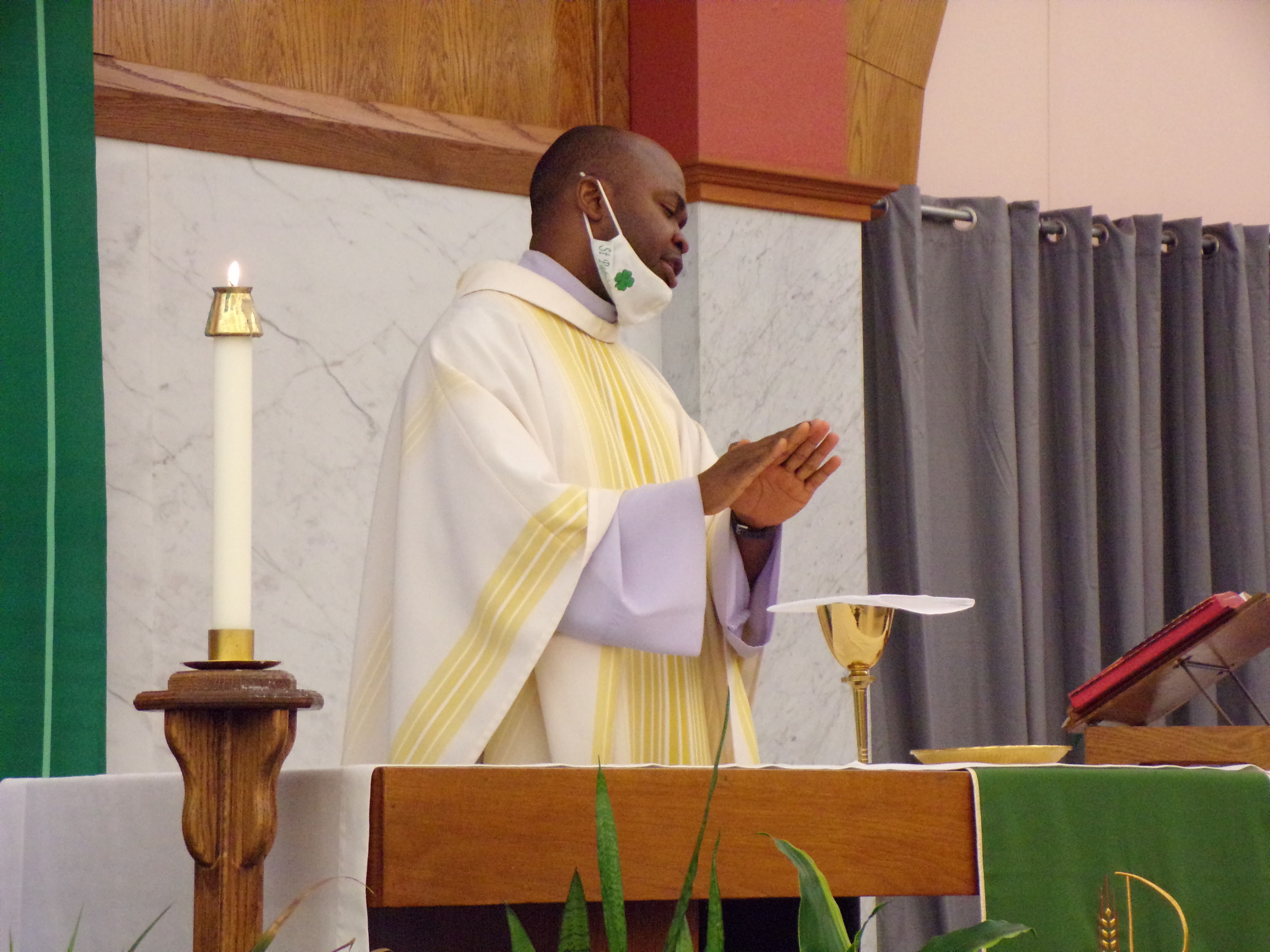 The Rev. Sebastian Ukoh, C.M. celebrates for Newman Center students.