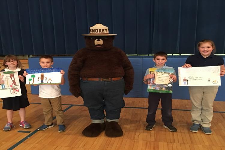 First Place poster Contest winners with Smokey Bear