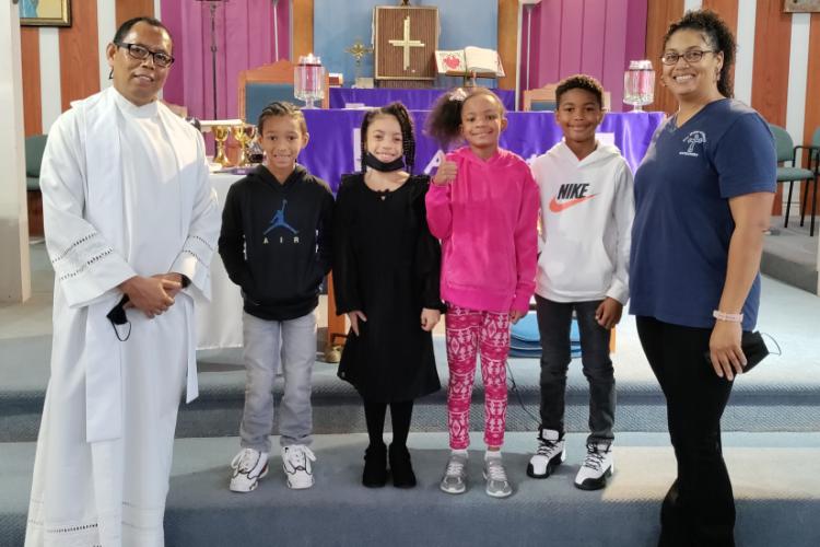 Fr. Jas and Catechist Chantel Normand Celebrate the Sacrament of First Reconciliation With the 2nd Grade Class
