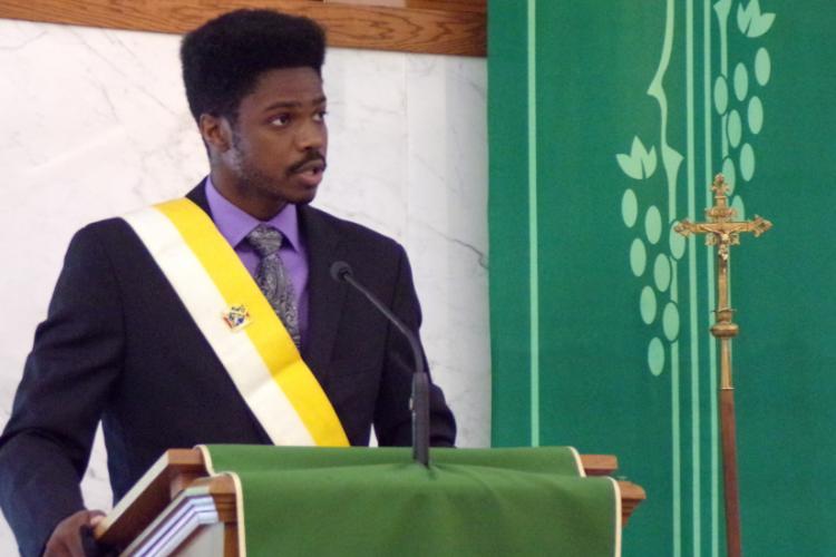 Southern Illinois University student Jamal Kinchen welcomes new members to the Knights of Columbus College Council #7682.