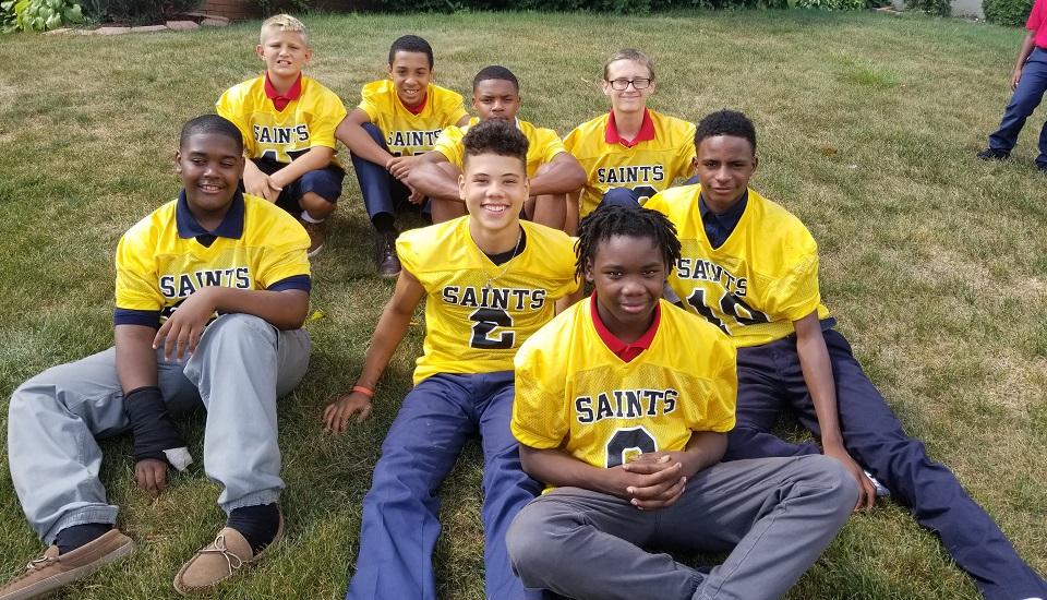 7th & 8th grade boys are gathered for a spirit rally before their big football game. St. Nicholas School players are members of the Youngstown Catholic Saints Football team. 