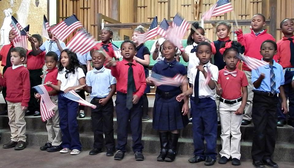 Kindergarten and 1st Grade sing "You're A Grand Old Flag"