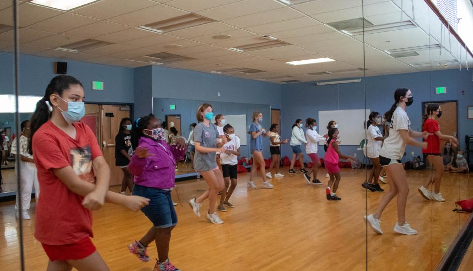 Middle school girls practiced a dance routine with their high school hosts in NDP’s mirrored dance studio.