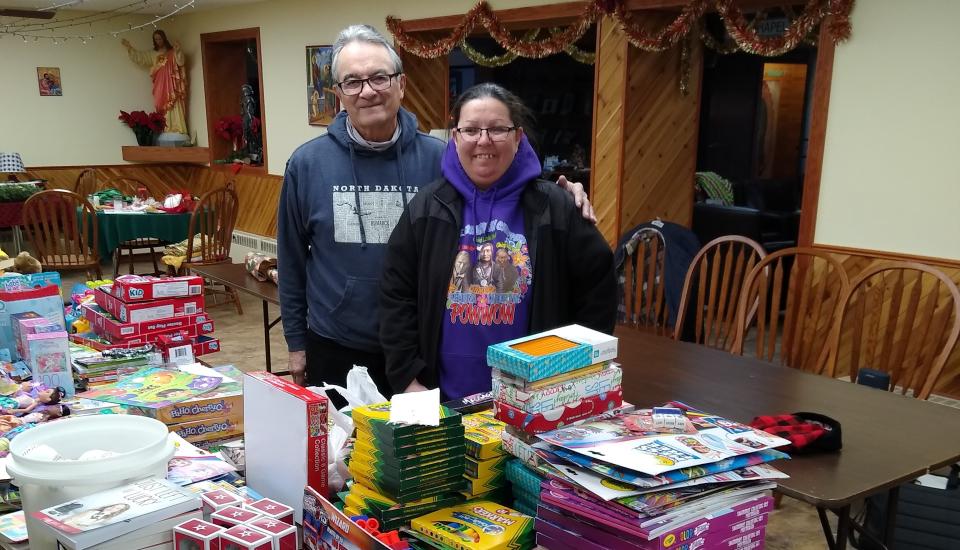 Toy drive organizers Duanne Gourneau and Jamie Charette look over the toys donated by parishioners of St. John Neumann Church in Canton, Mich.