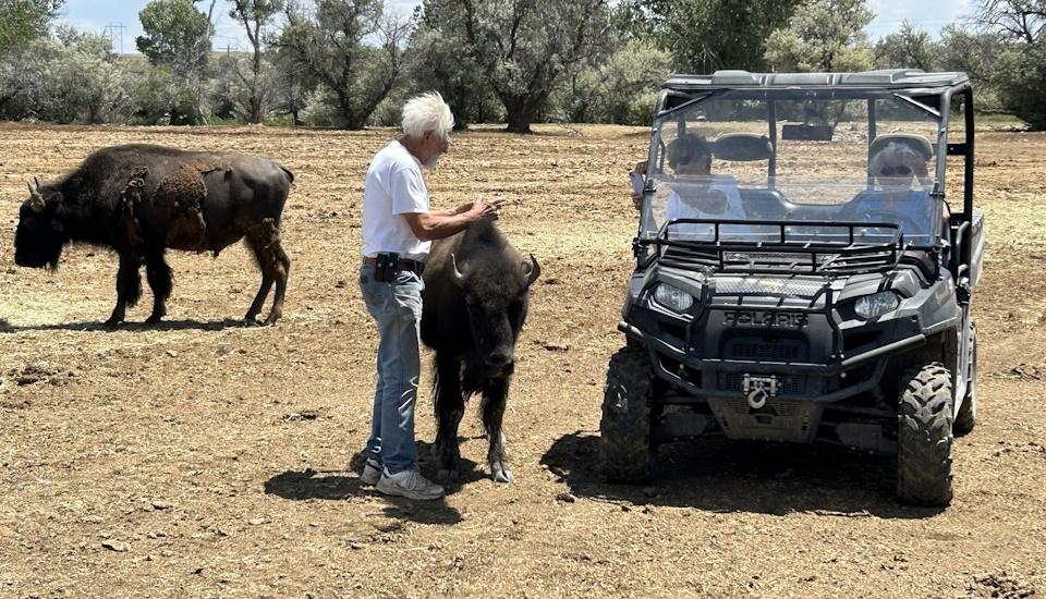 Ron Mamot, owner of the bison herd, gives a brief lesson to a few folks on retreat at St. Stephen’s.